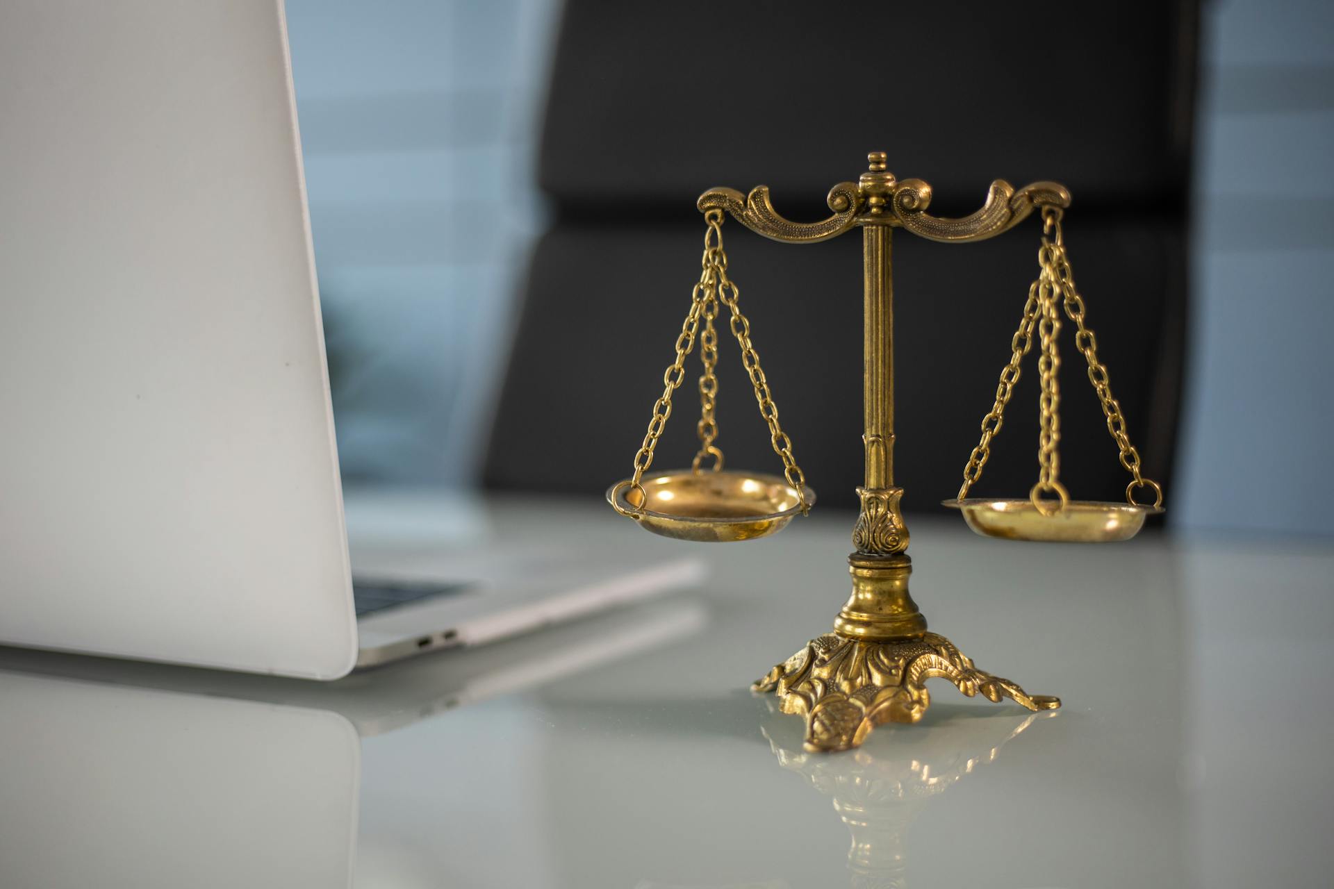 Golden scale symbolizing justice. Property and civil liability.