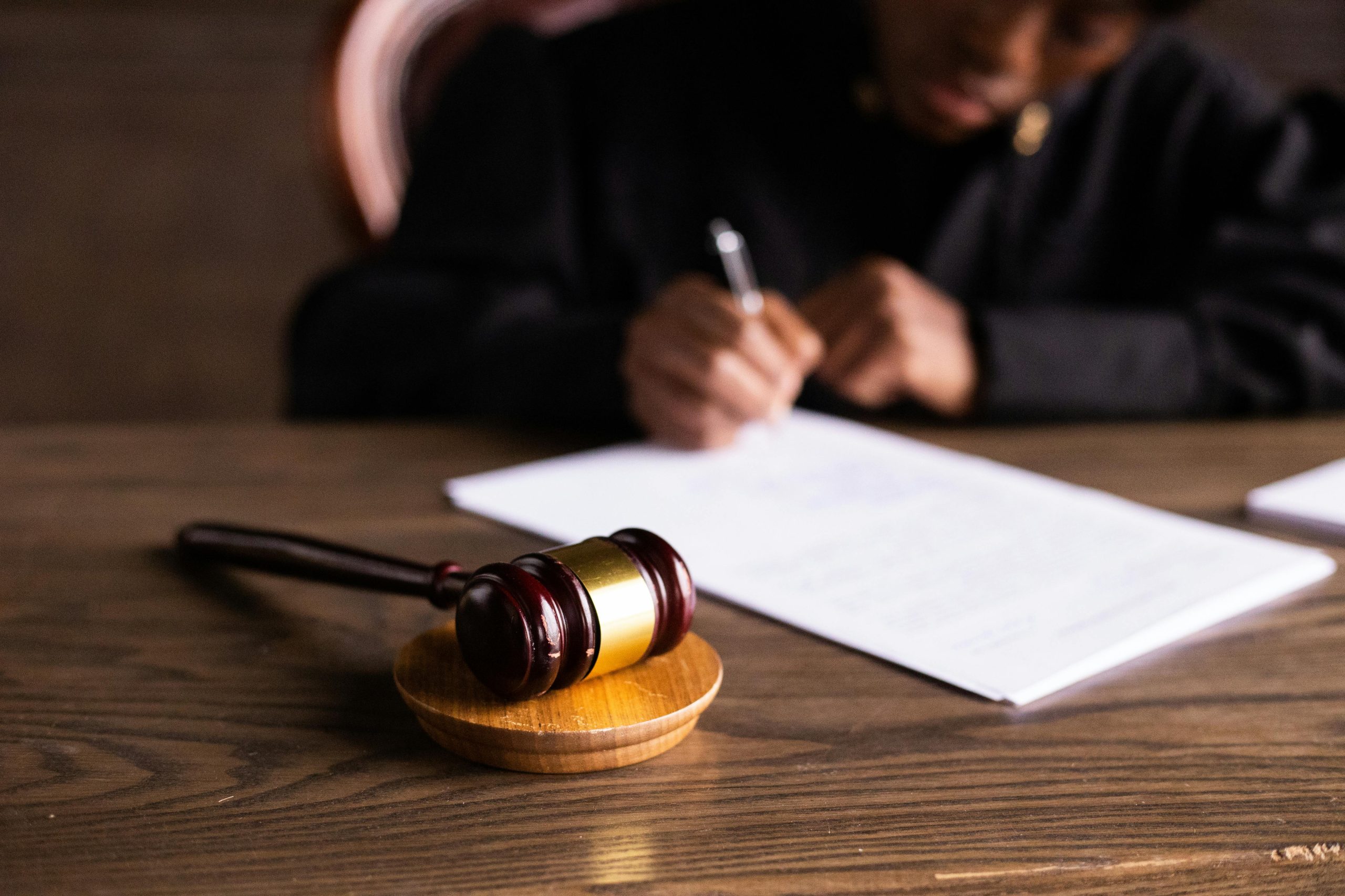Judge’s gavel placed beside a freshly signed contract.