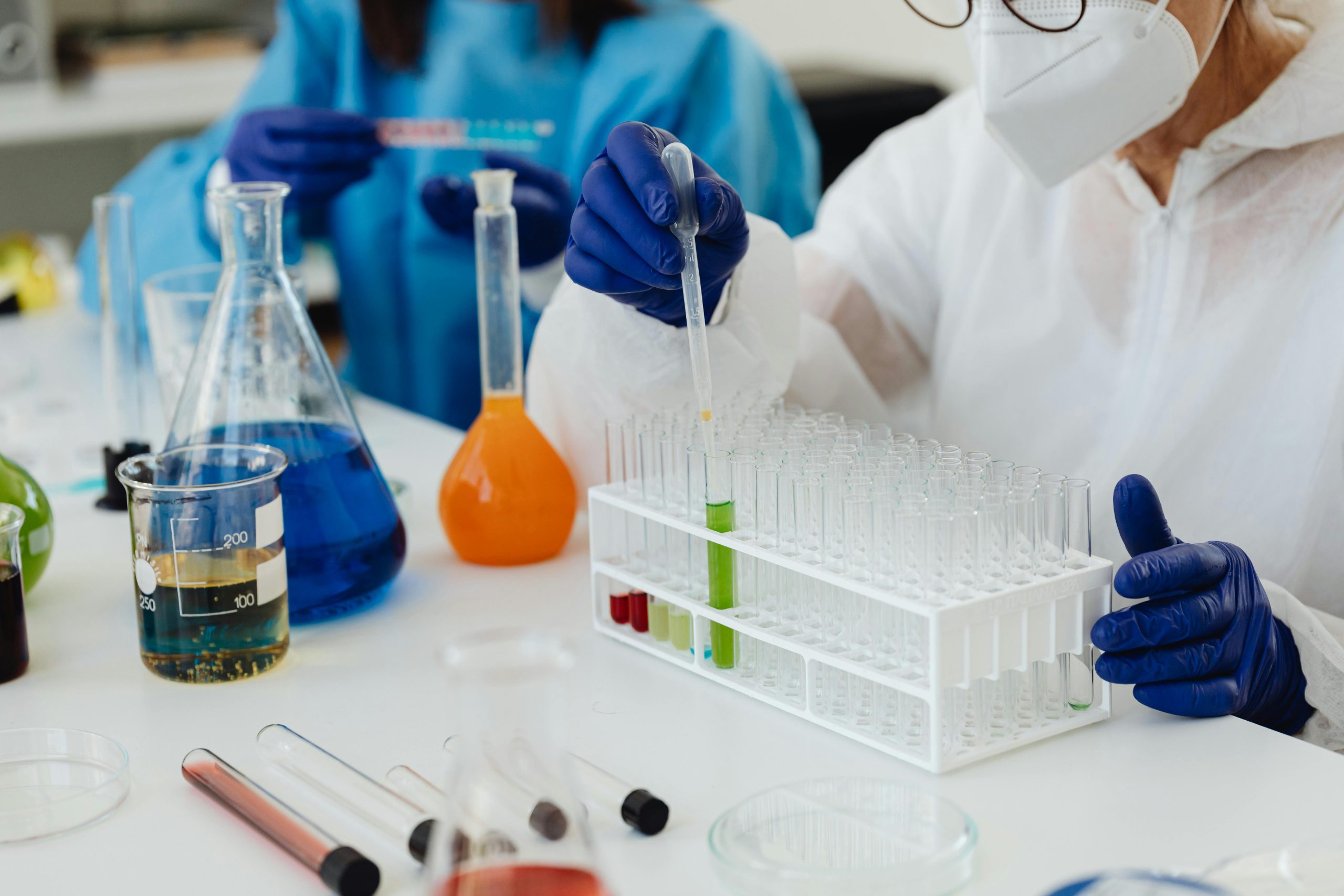 Two chemists are analyzing vials.