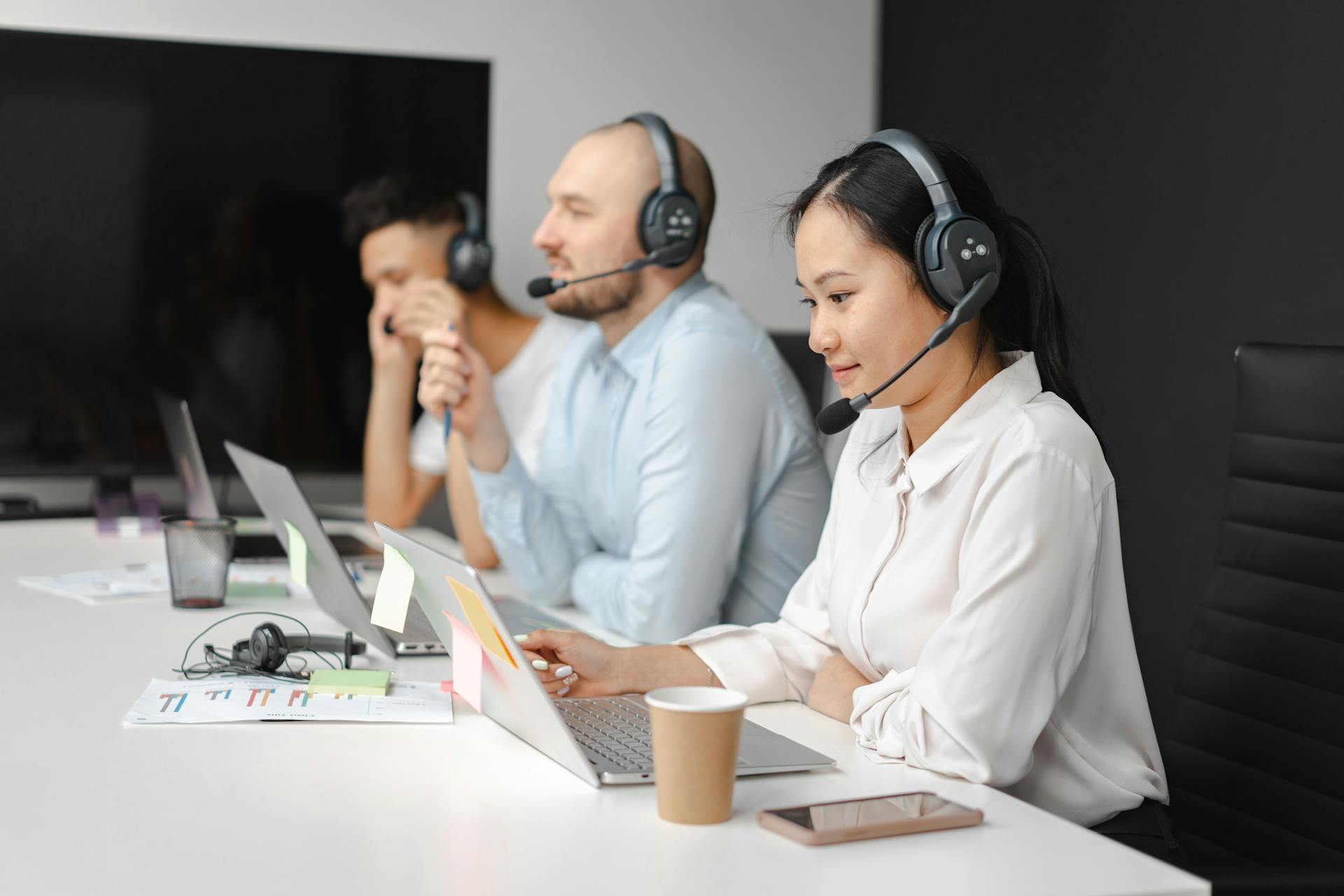Three people work in customer service.
