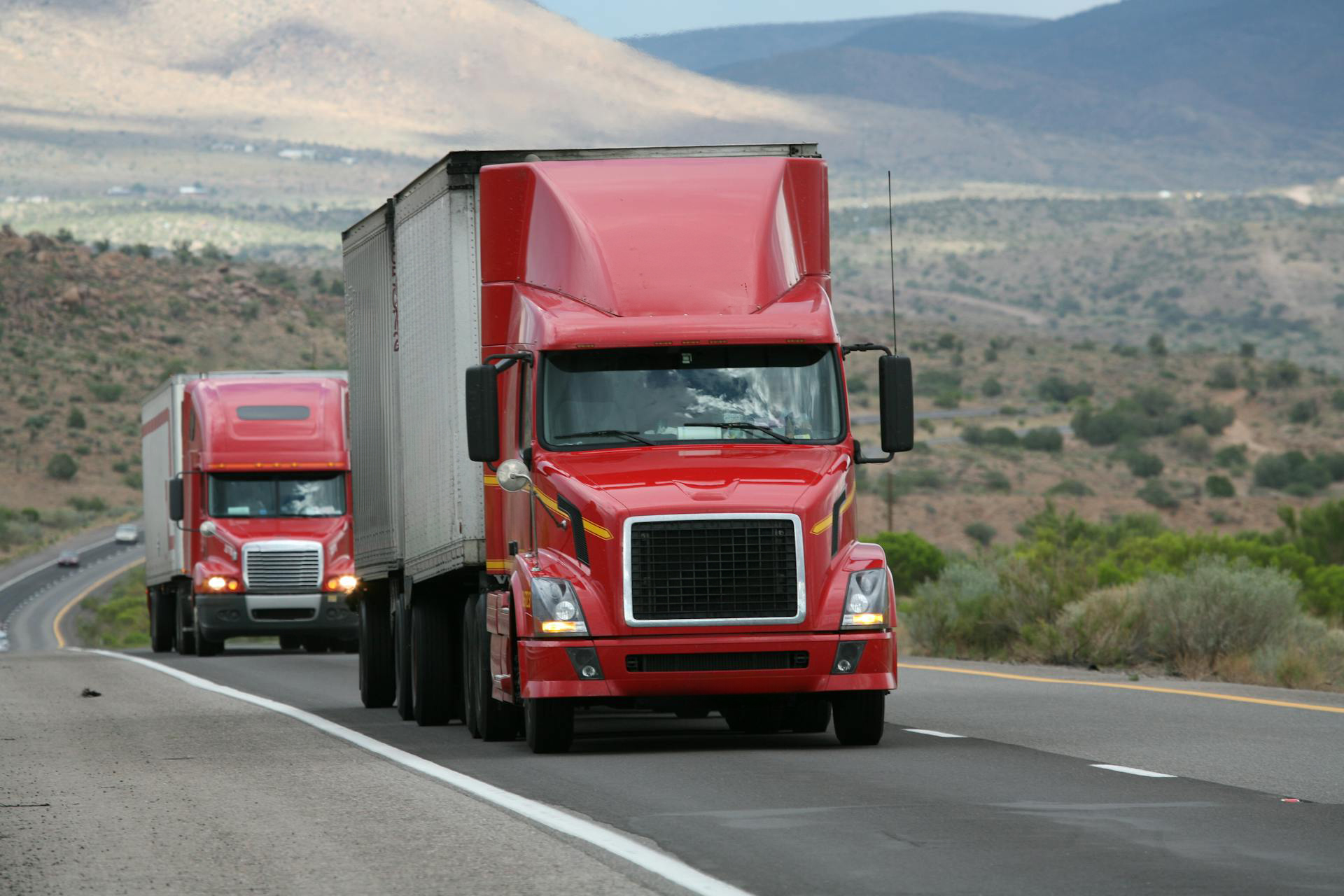 Red trucks on the highway.