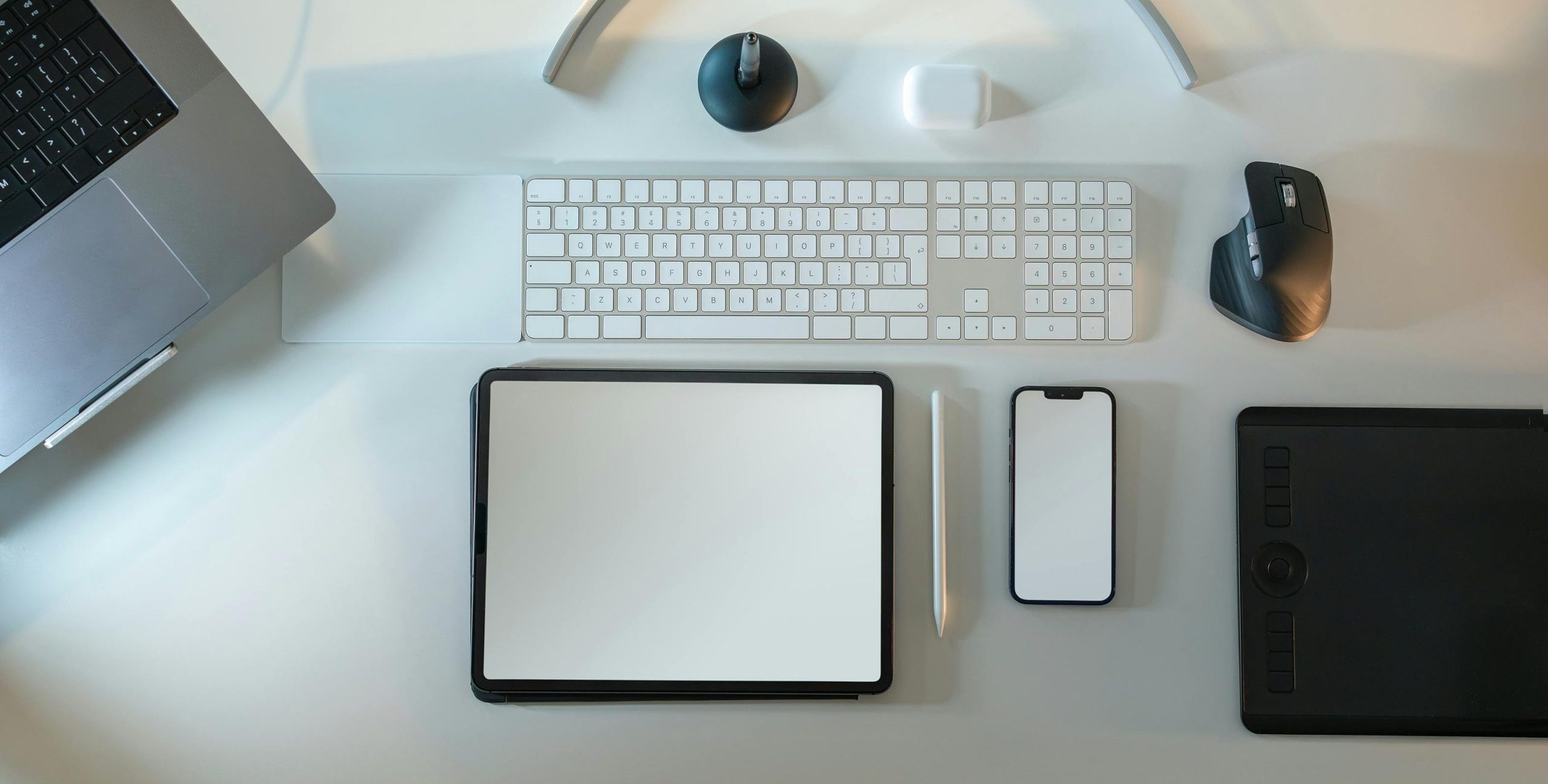 Tablet and cell phone on a desk.