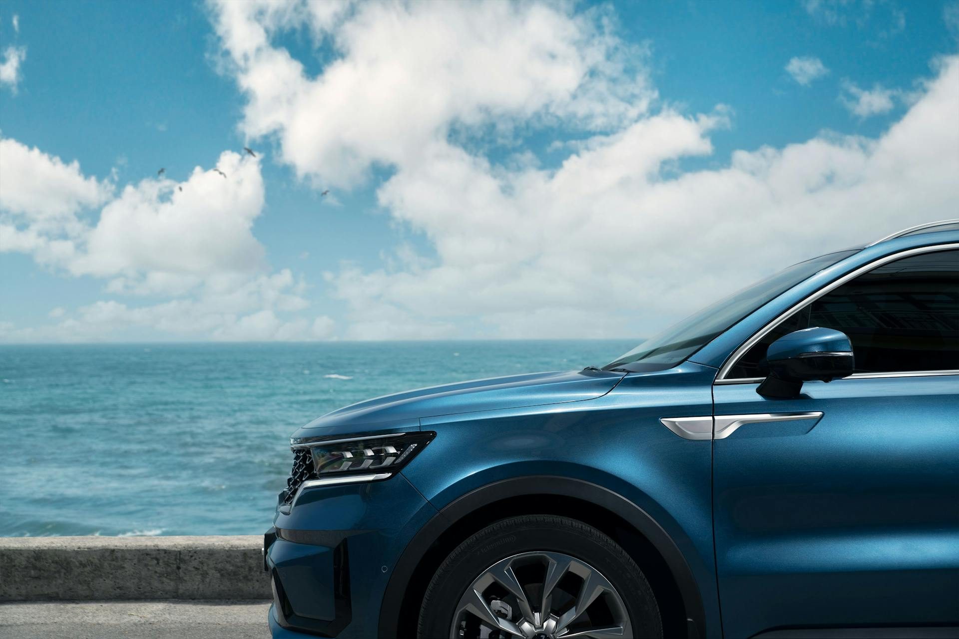Close-up of a blue car by the sea.